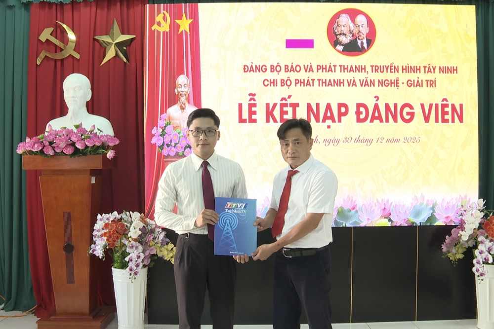 Bí thư Chi bộ Phát thanh và Văn nghệ giải trí Nguyễn Minh Hiếu (bên phải) trao Quyết định kết nạp đảng viên cho đồng chí Nguyễn Lữ Minh Lam